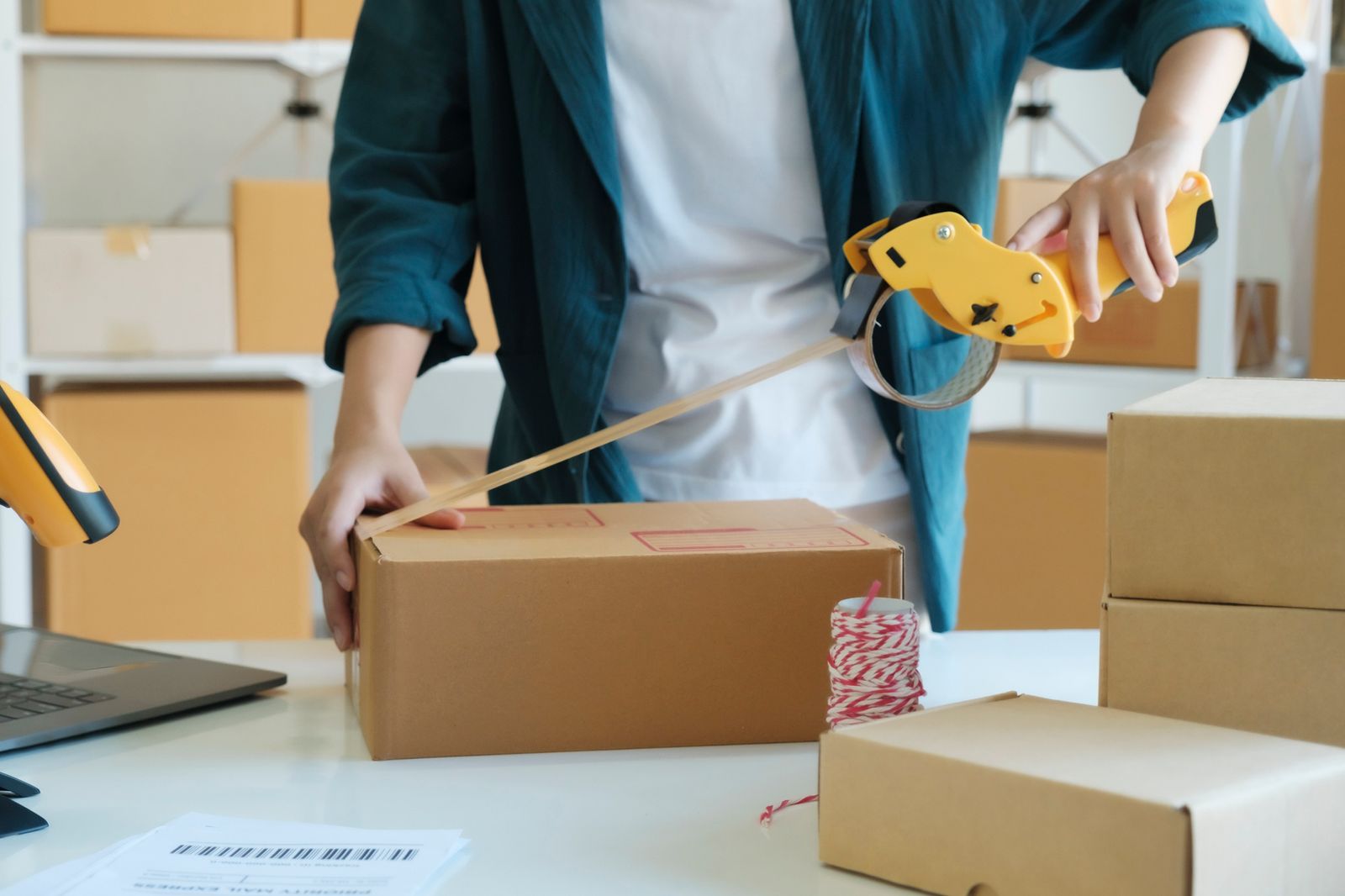 A young woman packaging products for online orders