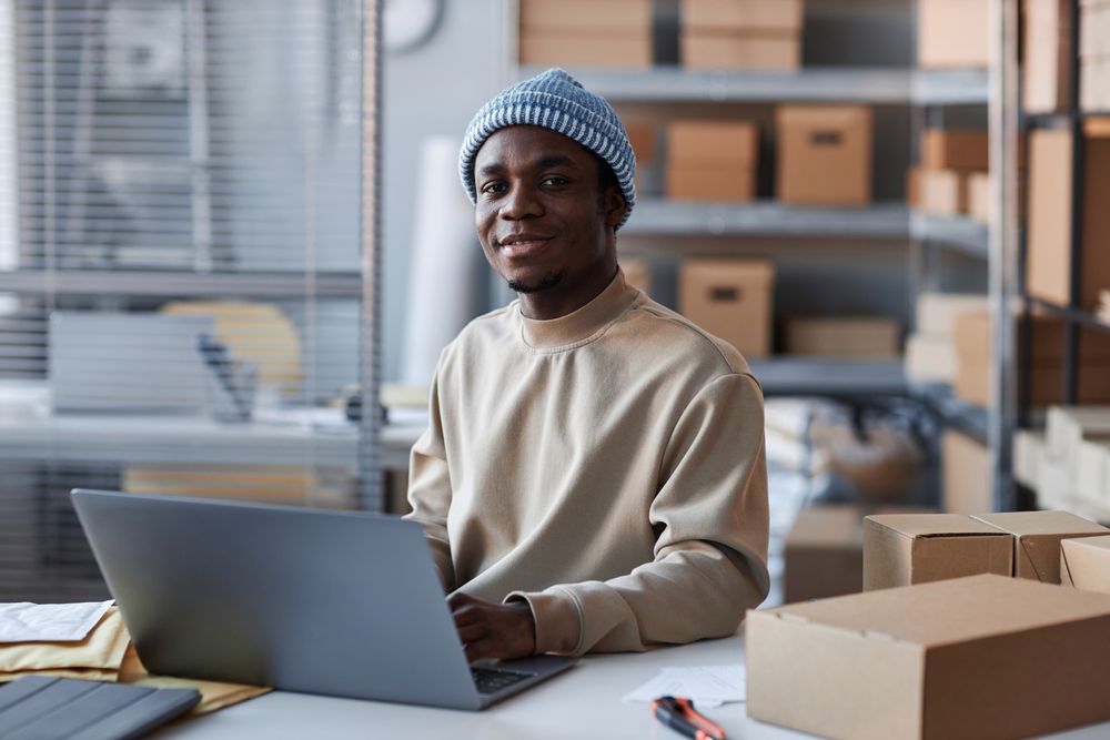 A male manager inspecting laptops in the warehouse