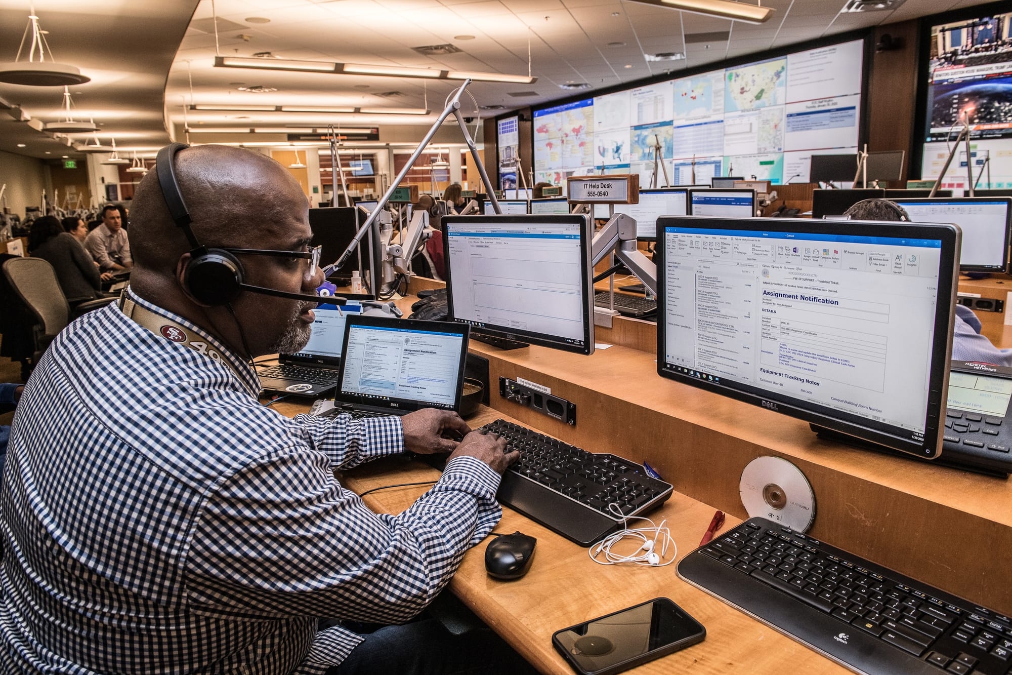 A customer service representative looking at a monitor.