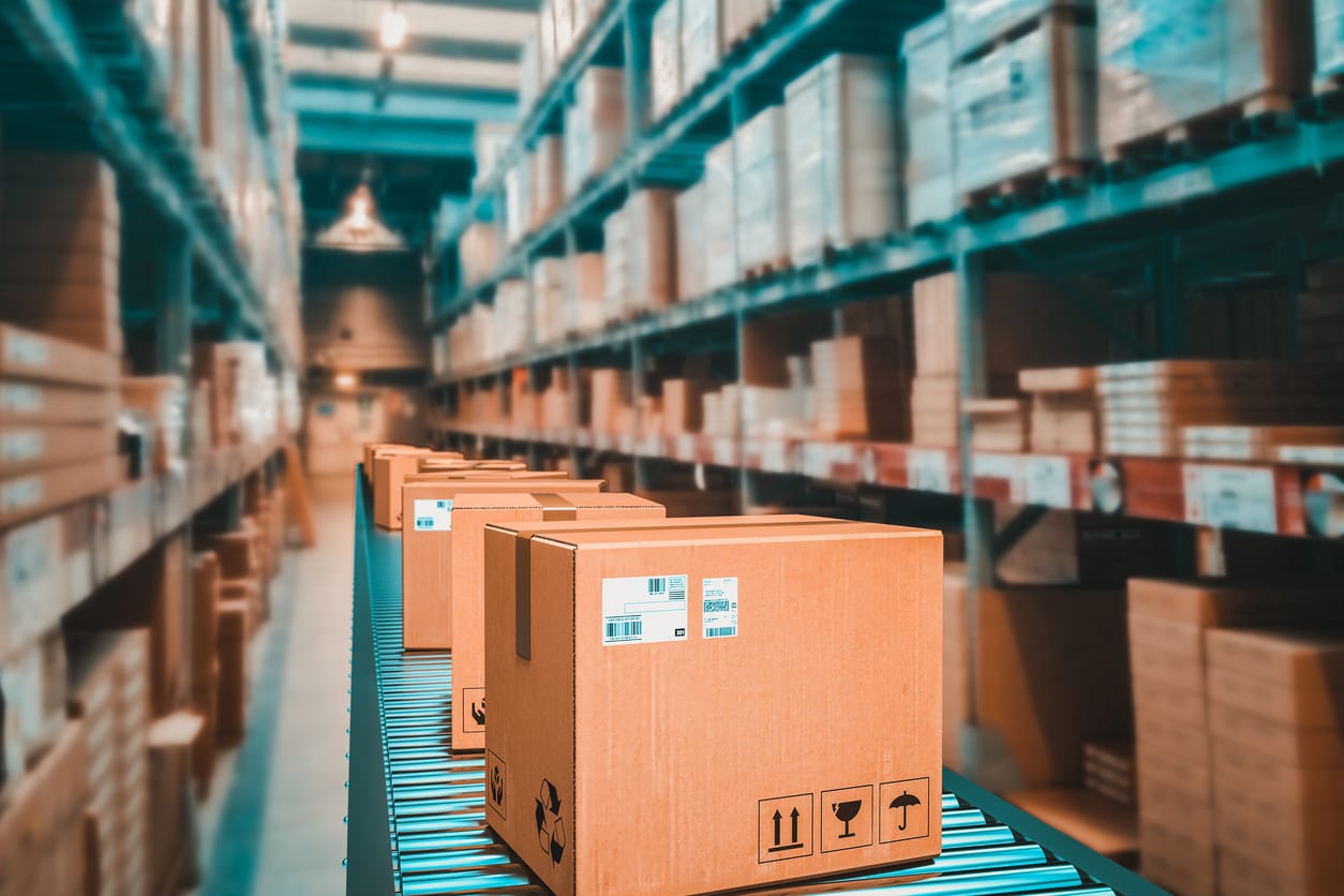 Parcels and packages on conveyor belt in a warehouse