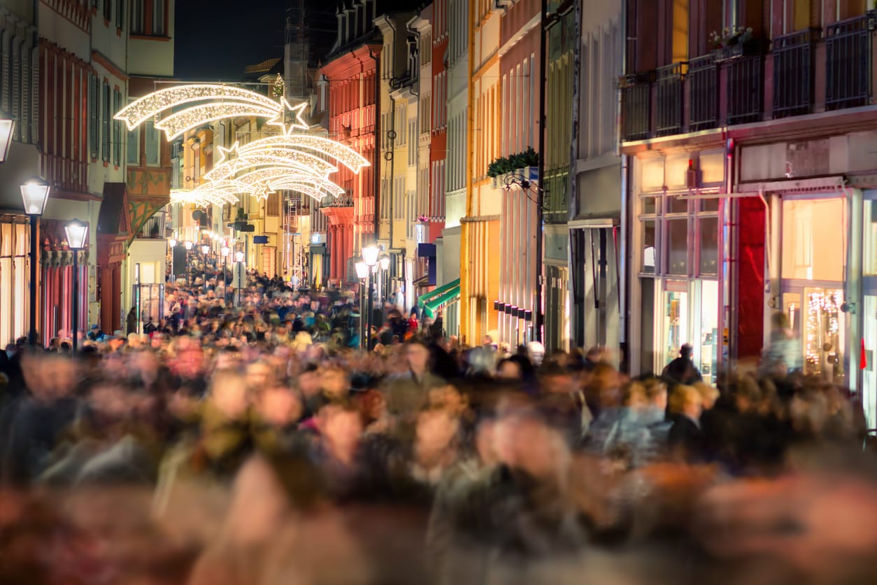 Large crowd of people hustling and shopping in a pedestrian area for the holidays