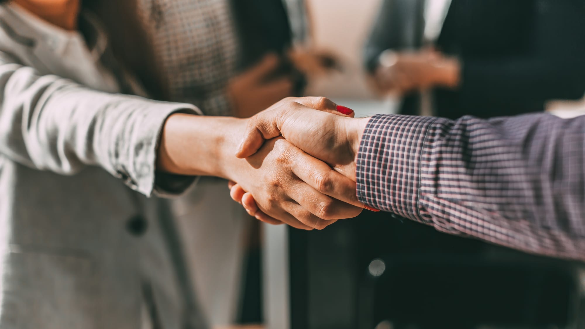 Close up. f young casual business people shaking hands with each other