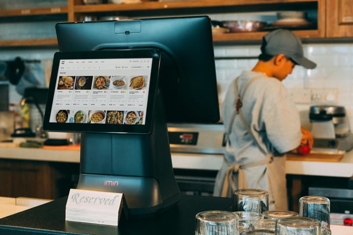 A busy restaurant with staff preparing orders 