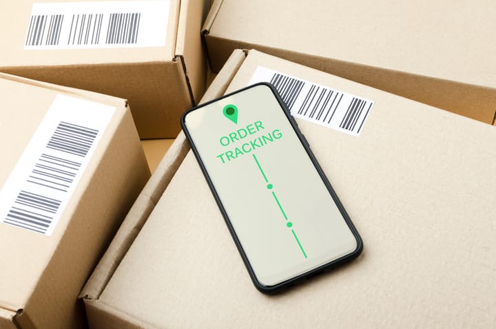 Delivery tracking form on cardboard boxes with barcode labels. Concept of order tracking system.